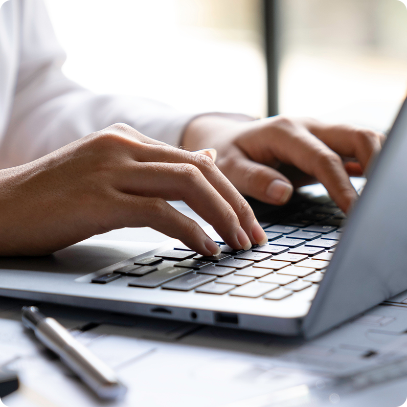 Person typing on a laptop keyboard
